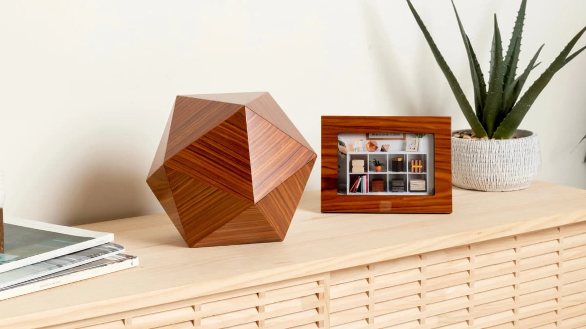 Geometric wooden urn on a modern shelf with photo frame and plant